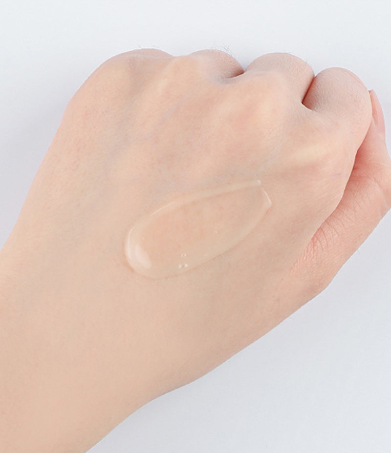 Close up of the Age Defying Essence Forte texture on the back of a person's hand. 