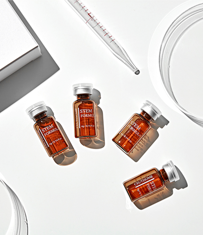  Four bottles of oxygen skincare product Ceutisome Stem Formula showcased against a backdrop of lab beakers and test tubes.