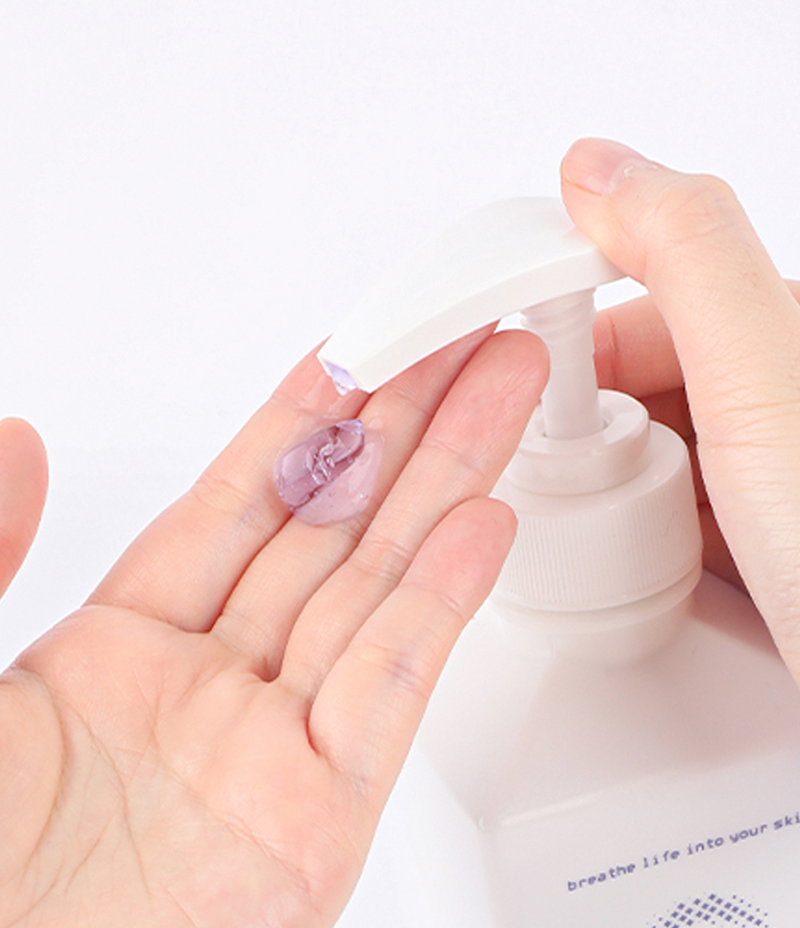 A person is extracting a small amount of soothing CICA Contour V Gel into their hand for skincare routine. 
