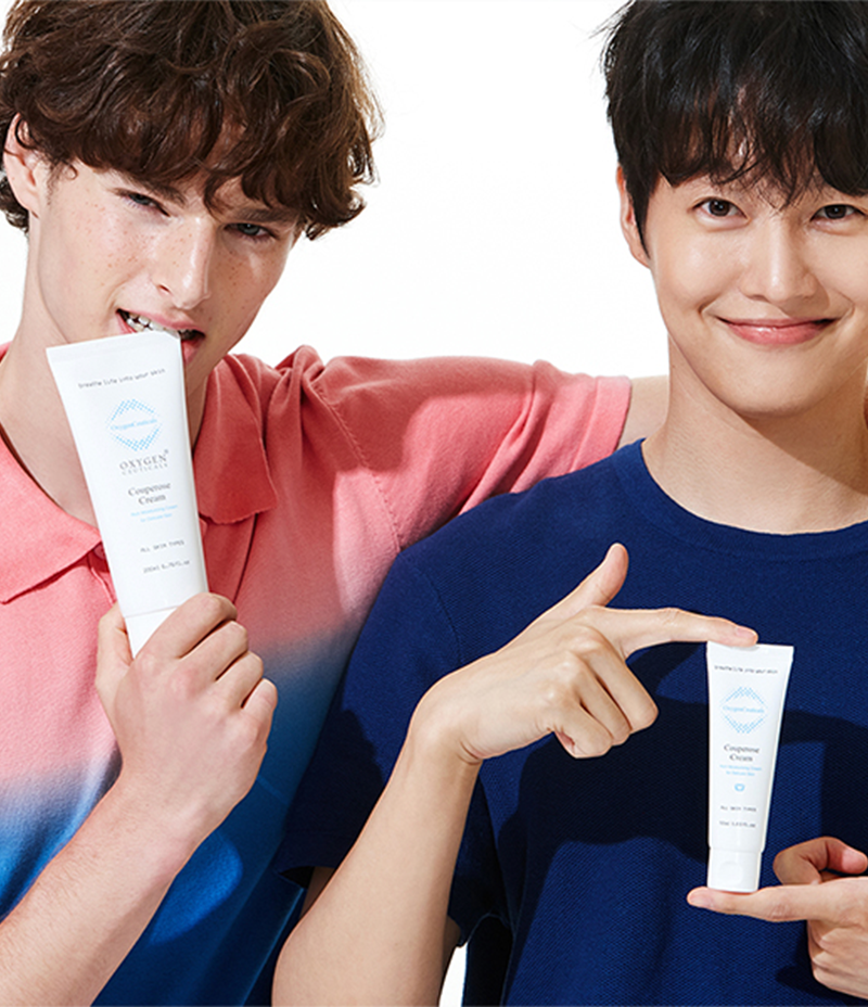 Smiling gentlemen with two tubes of soothing acne Couperose Cream.
