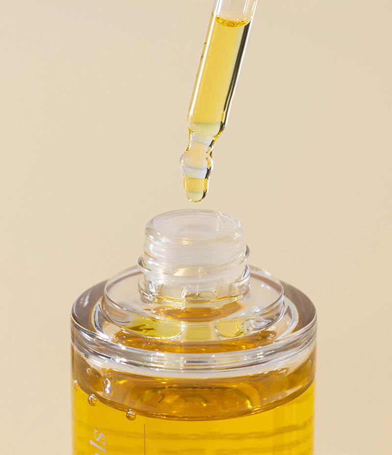 Closeup image highlighting the versatile multi-function properties of golden Jojoba Oil.