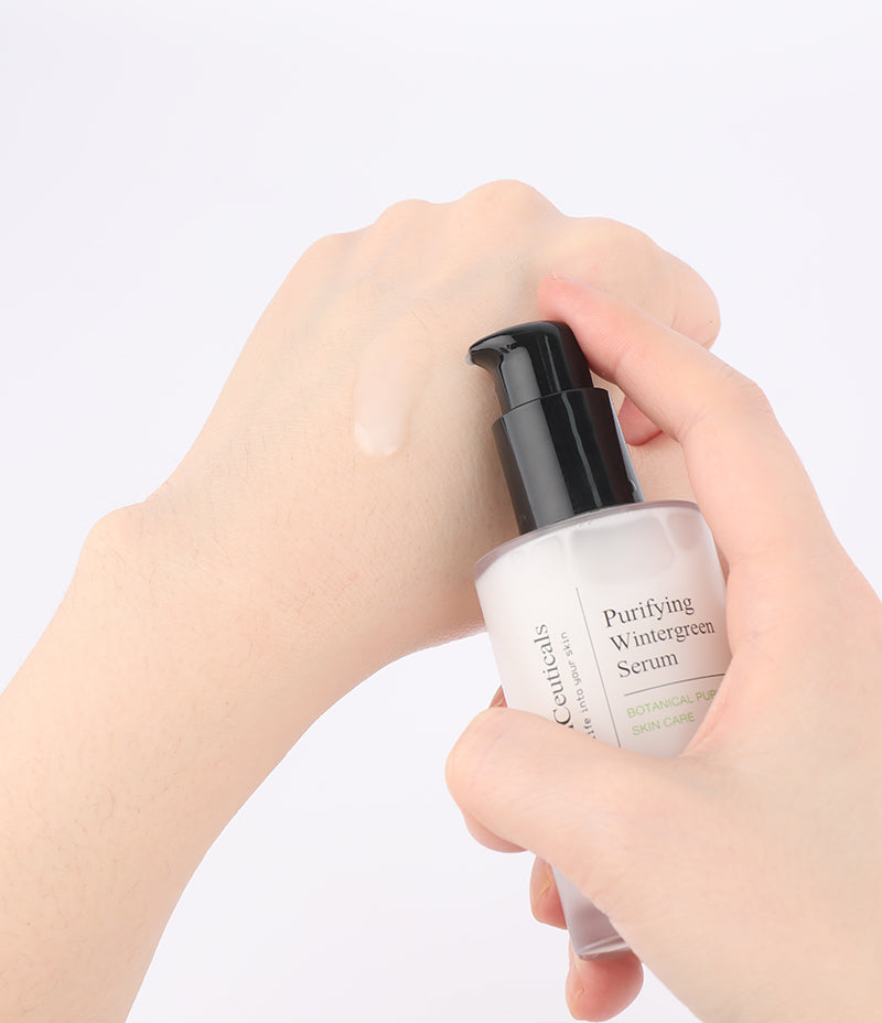 Application of lightweight Purifying Wintergreen Serum on a person's hand, perfect for oily skin.