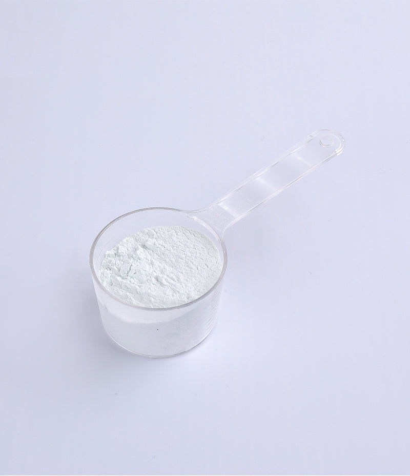  close-up view of a measuring cup filled with RT Mask powder, offering soothing skincare benefits.