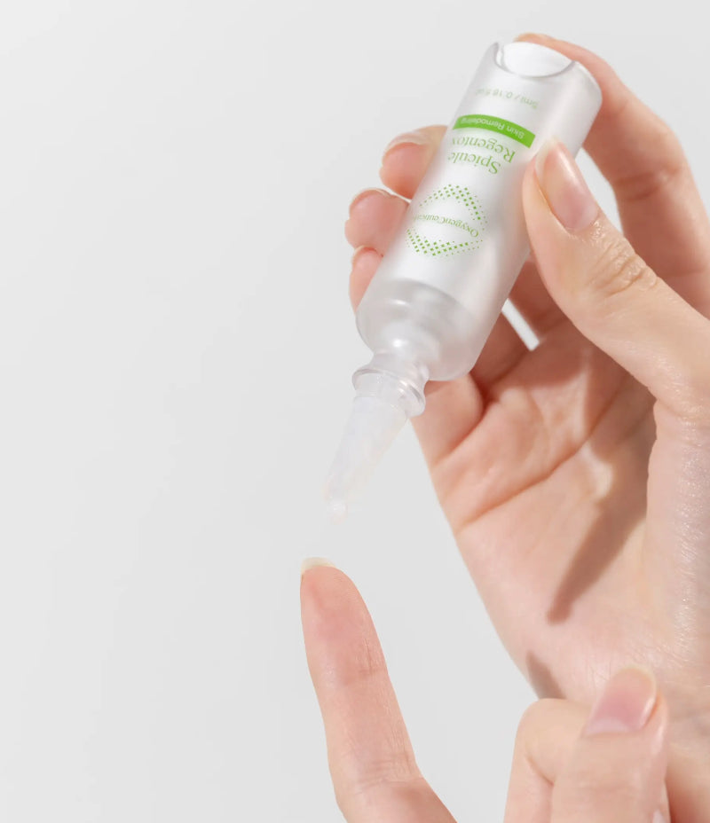 mage displaying the application of Spicule Regentox's emulsion texture on a finger tip, perfect for acne-prone skin.