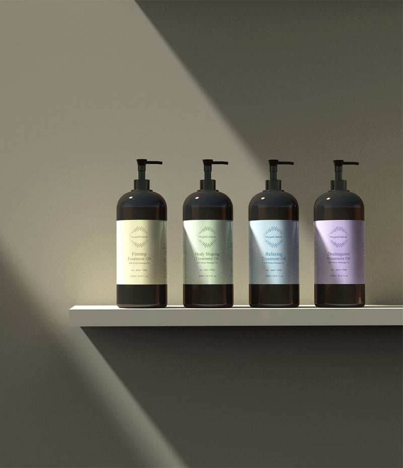 Collection of four Treatment Oil products for massage therapy, aligned on a shelf.