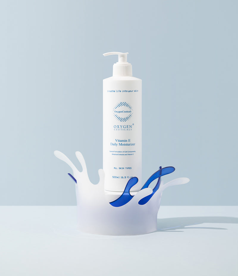 Stylish presentation of Vitamin E moisturizer with artistic water splash cutouts in the background.