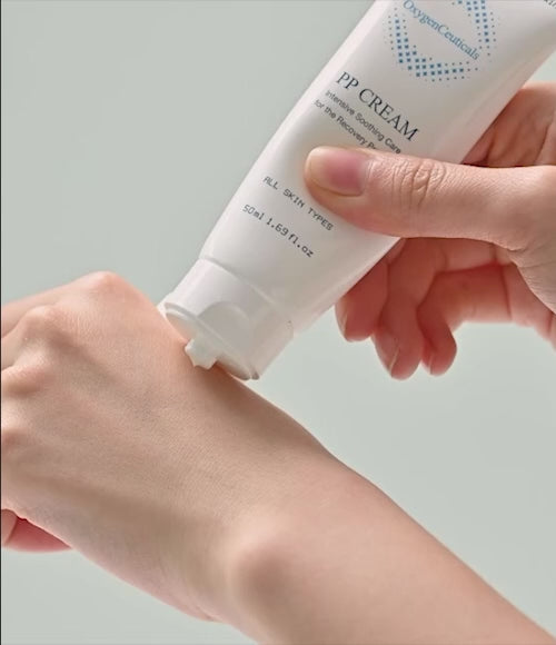 Closeup video of a person applying the skin recovery balm PP Cream to the back of their hand.