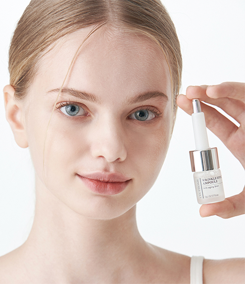 Model holding up a bottle of Ceutisome Wrinkle Effect Ampoule enriched with 7 peptide complex for skin elasticity.