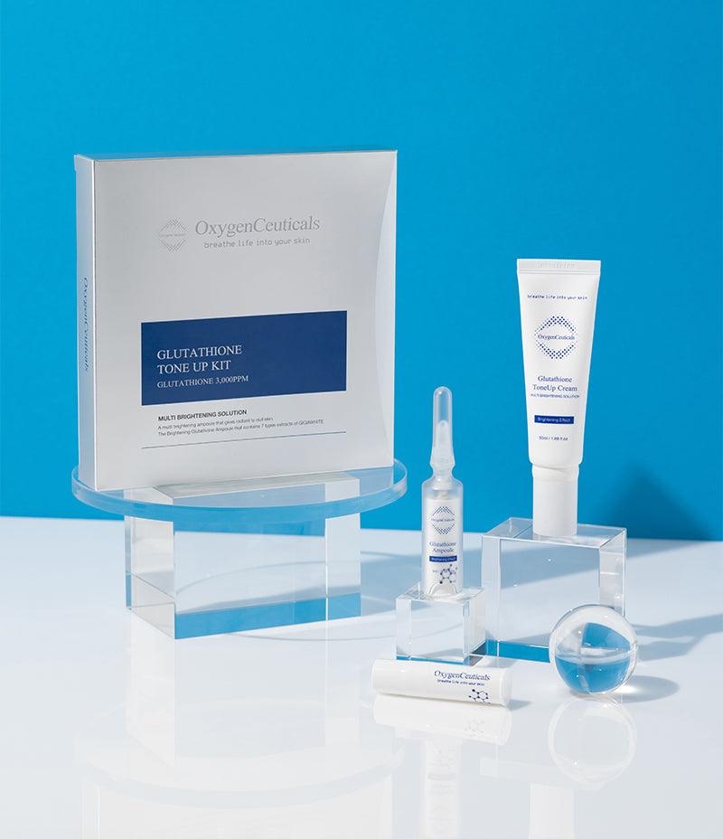 An artistically arranged display of Brightening Glutathione Set featuring Glutathione Ampoule and Tone Up Cream with a bright blue background.
