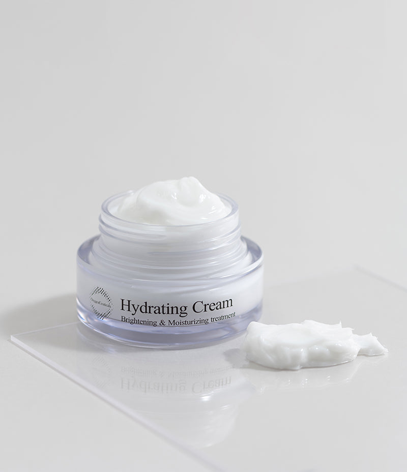 Open tub of moisturizing cream that holds up to 1,000 times its weight in water, sitting on a shiny white tabletop with a dollop of its rich formula beside it.