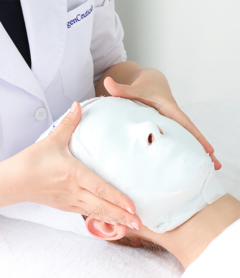 Skincare expert performing hydrating routine with removal of a hardened modeling mask.