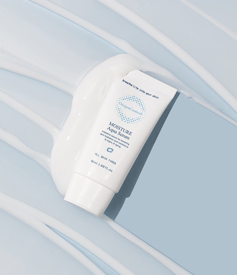  A tube of white cream on a blue surface, representing Moisture Aqua Serum, an intensive hydration gel-type serum with Hyaluronic Acid.