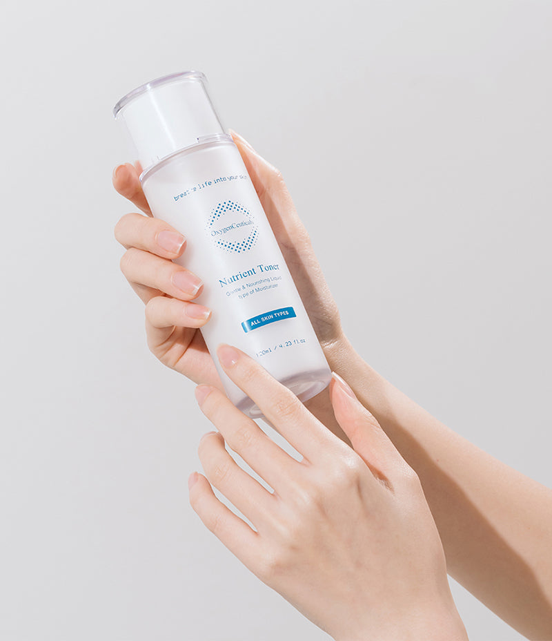 A person holding a bottle of white liquid labeled 'Nutrient Toner', ready to nourish and revitalize the skin.