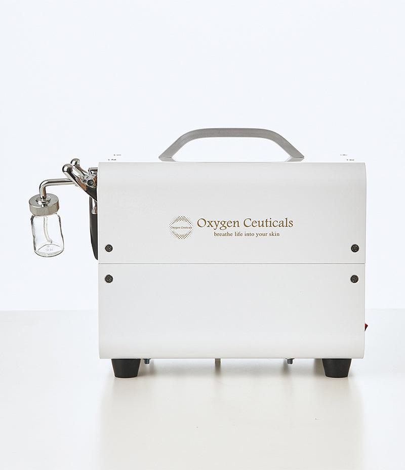 OZ Portable as viewed from the side with ampoule cup and logo.  Used for Oxygen facial. Can be used with masker oxygen, oxygen mask, oxygen serum, oxygen skincare, what is a misting device used for facial treatments, image oxygen facial.