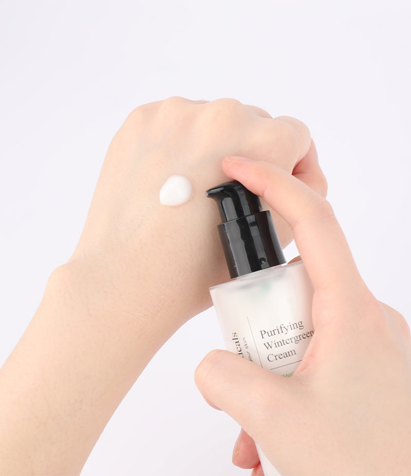 Hand application of Purifying Wintergreen Cream for sebum control.