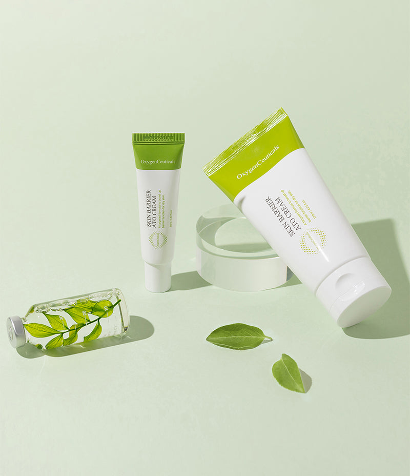 Skin care product Skin Barrier Ato Cream used for atopy, displayed next to vibrant green leaves on a pastel green background.