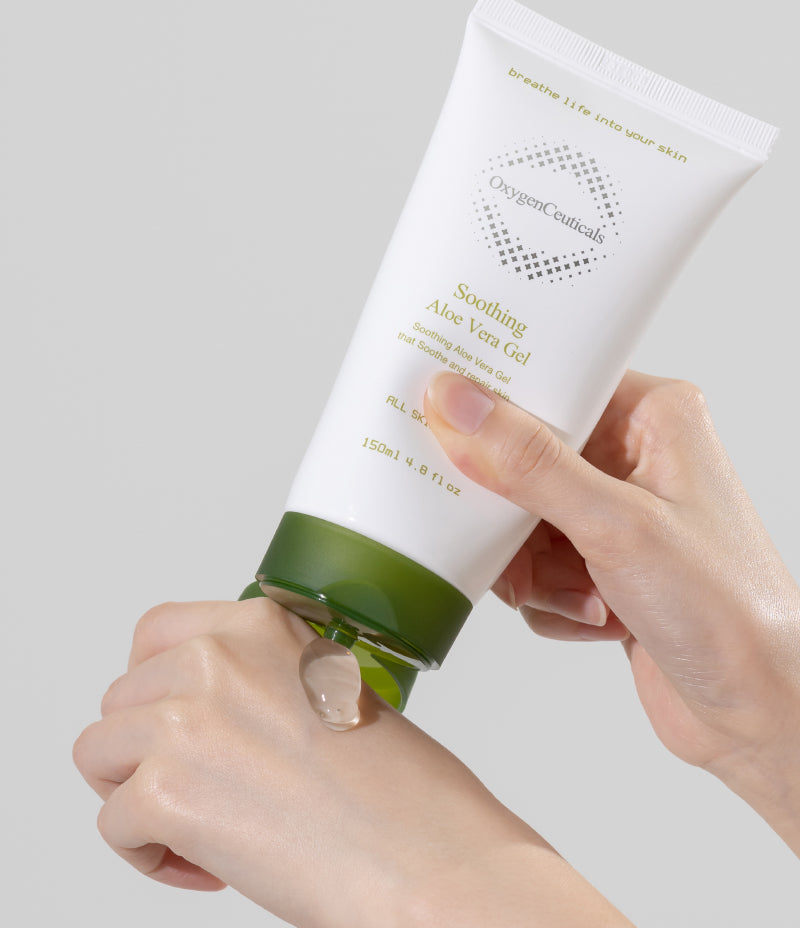 A person gently applying soothing aloe vera gel enriched with vitamin E onto their skin.