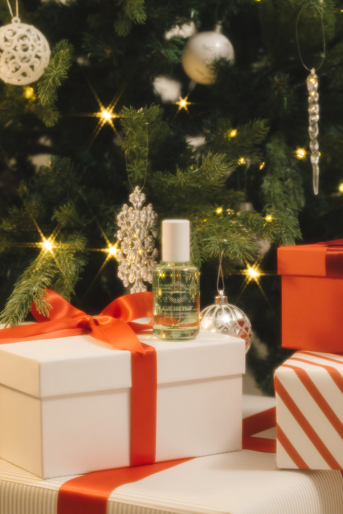 OxygenCeuticals' ultra-hydrating ampoule, the Acell-300 Fluid, displayed among christmas gifts and tree ornaments.