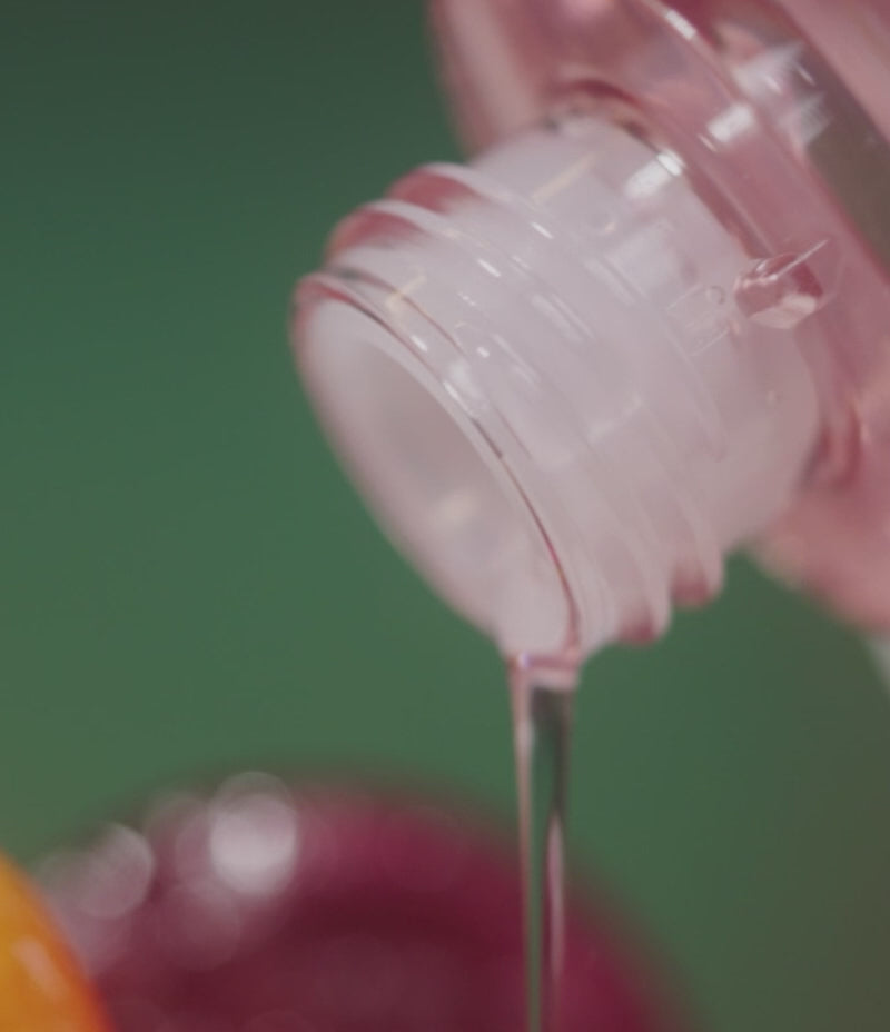 Video demonstrating the pouring of Fermented Fluid onto brightly-colored candies, used as an illustrative tool for explaining hyperpigmentation. 